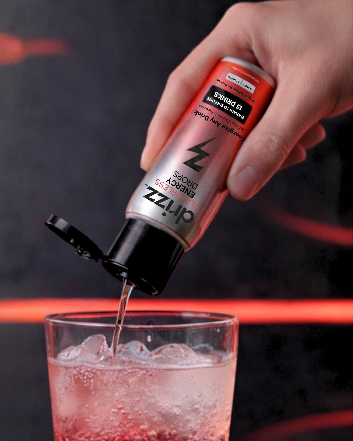 Drizz Flavorless Energy Drops being squeezed into a glass — liquid caffeine drops in use